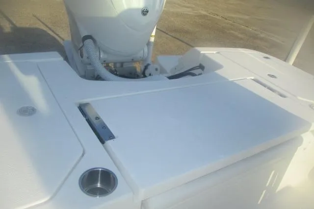 Slide: The Image of 2026 Caymas 24 HB boat deck with motor and cup holder. - 4