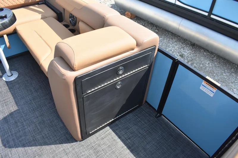 Slide: The Image of 2026 Godfrey SWEETWATER 2286 SFL boat interior with tan seating and storage compartment. - 12