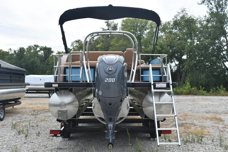 Slide: The Image of 2026 Godfrey Sweetwater 2286 SFL Tritoon with Yamaha 200 engine, parked outdoors. - 2
