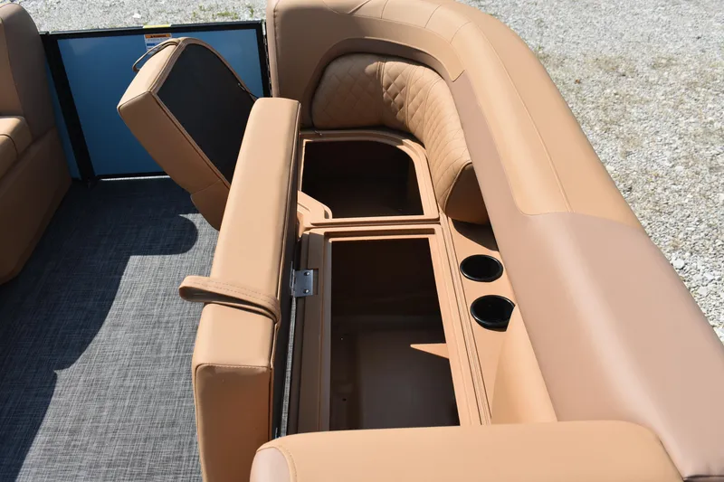 Slide: The Image of 2026 Godfrey SWEETWATER 2286 SFL boat interior with tan seating and storage compartments. - 21