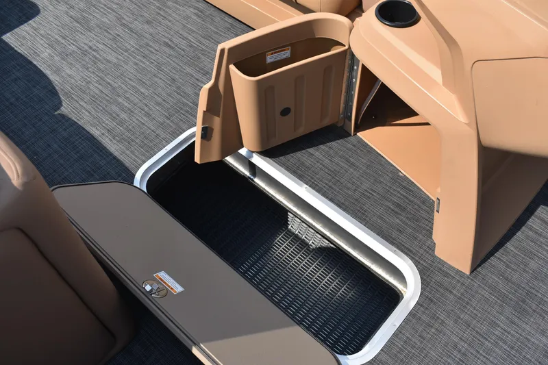 Slide: The Image of 2026 Godfrey SWEETWATER 2286 SFL boat storage compartments with open hatches and cup holder. - 22