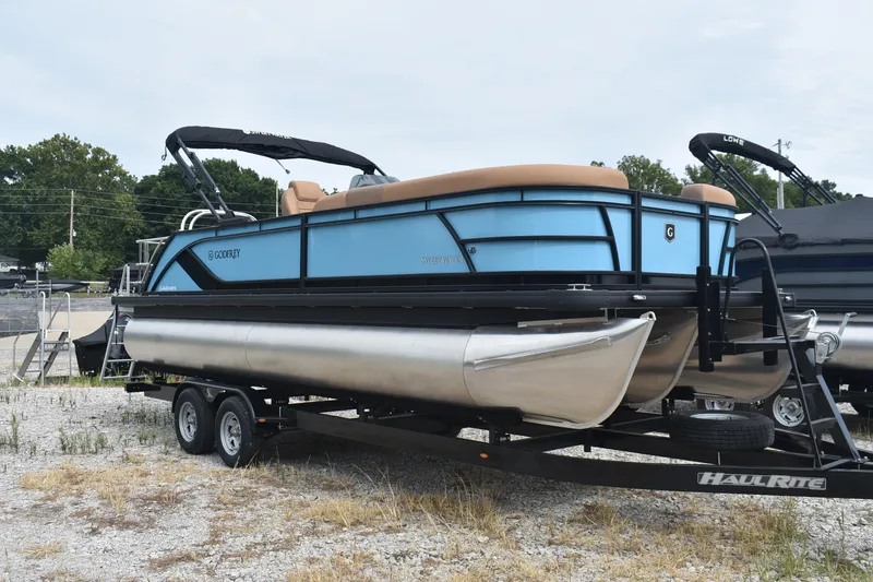 Slide: The Image of 2026 Godfrey Sweetwater 2286 SFL Tritoon on trailer, blue exterior, parked outdoors. - 4