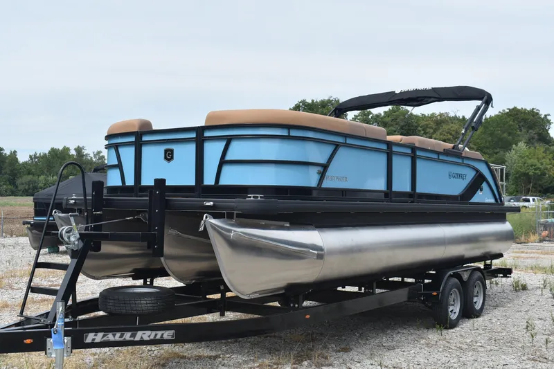 Slide: The Image of 2026 Godfrey Sweetwater 2286 SFL Tritoon on trailer, blue and tan design. - 5