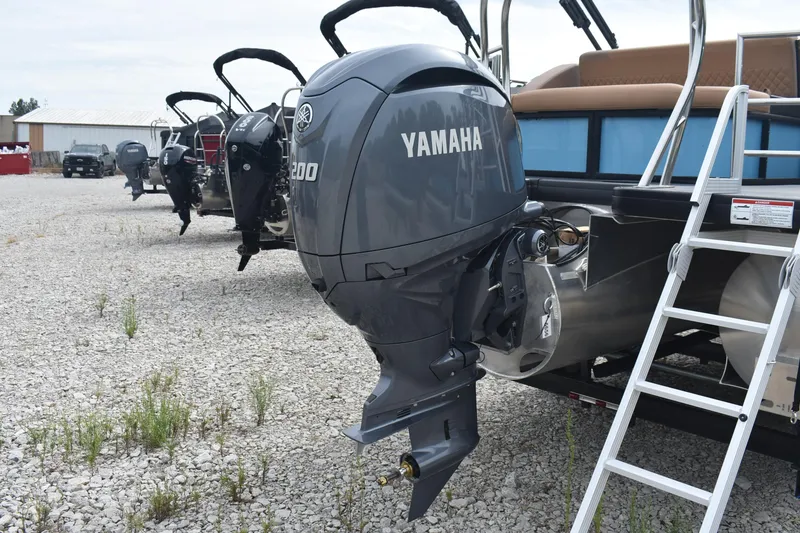 Slide: The Image of 2026 Godfrey Sweetwater 2286 SFL Tritoon with Yamaha outboard motor on gravel lot. - 6