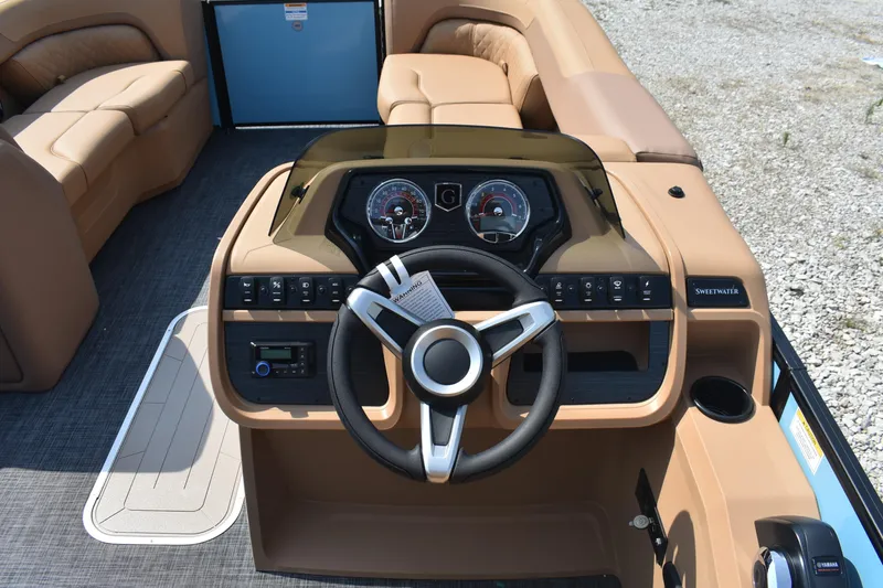 Slide: The Image of 2026 Godfrey SWEETWATER 2286 SFL boat dashboard with steering wheel and controls. - 8
