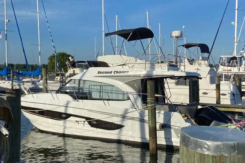 Slide: The Image of 2022 Beneteau Antares 11 Fly yacht docked at marina under clear blue sky. - 3