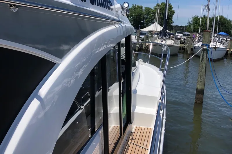 Slide: The Image of 2022 Beneteau Antares 11 Fly docked at marina, side view. - 4