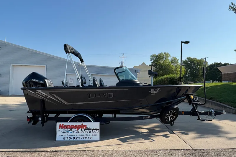 The Image of 2026 Lund 1875 Pro-V Sport boat on trailer at Hennepin Marine dealership. - 0