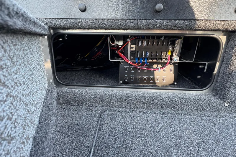 Slide: The Image of Electrical panel inside 2026 Lund 1875 Pro-V Sport boat, showcasing wiring and components. - 12