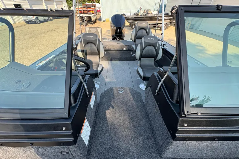 Slide: The Image of 2026 Lund 1875 Pro-V Sport boat interior with seating and steering console. - 13