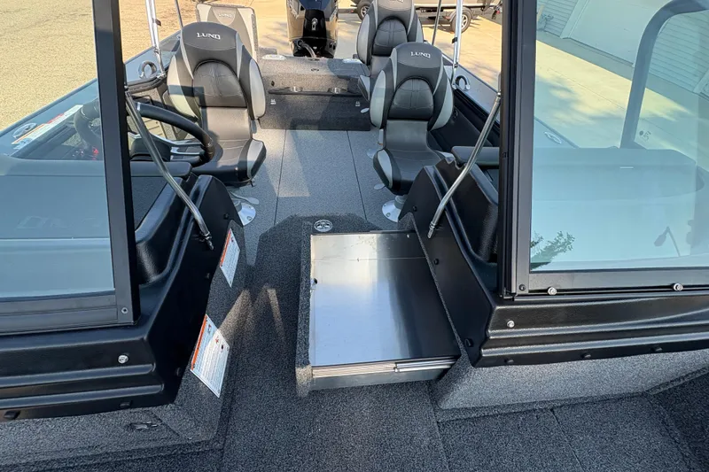 Slide: The Image of 2026 Lund 1875 Pro-V Sport boat interior with seating and steering wheel. - 14
