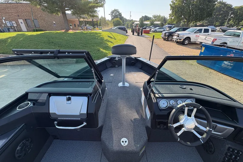 Slide: The Image of 2026 Lund 1875 Pro-V Sport boat interior with steering wheel and dashboard view. - 15