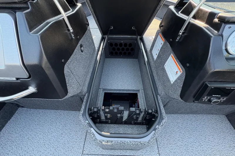 Slide: The Image of 2026 Lund 1875 Pro-V Sport boat interior storage compartment with open lid. - 16