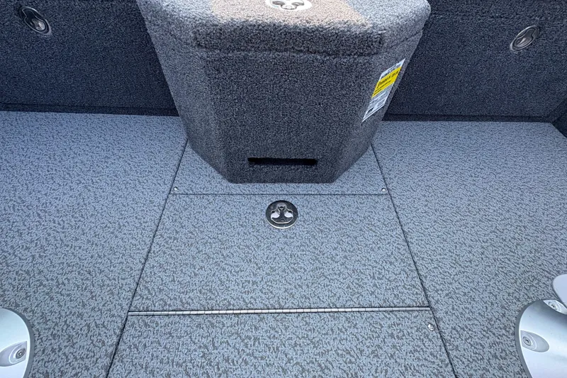 Slide: The Image of Interior view of 2026 Lund 1875 Pro-V Sport boat, featuring carpeted flooring and storage compartments. - 18