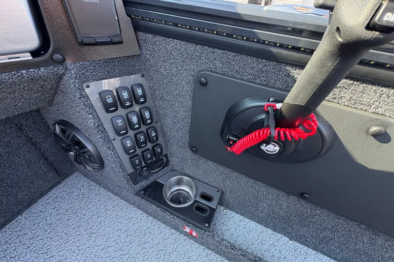 Slide: The Image of Interior of 2026 Lund 1875 Pro-V Sport boat with control panel and cup holder. - 24