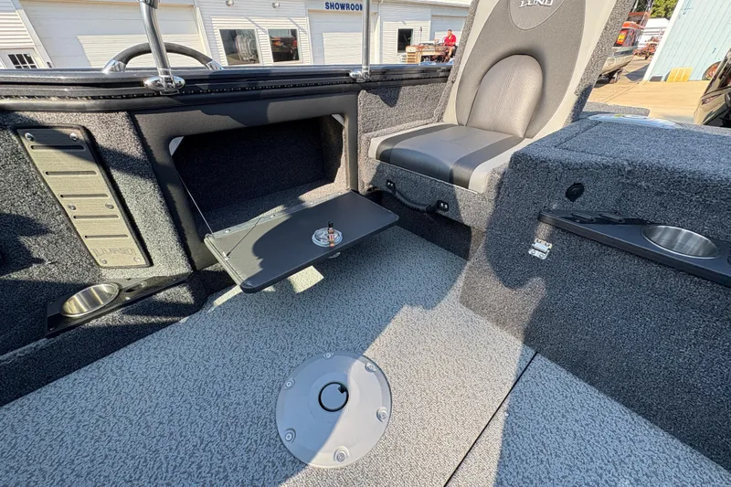 Slide: The Image of 2026 Lund 1875 Pro-V Sport boat interior with seating and storage compartments. - 28