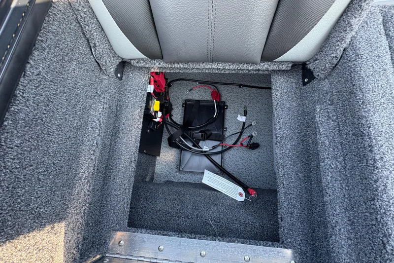 Slide: The Image of Interior view of 2026 Lund 1875 Pro-V Sport boat compartment with wiring and components. - 34