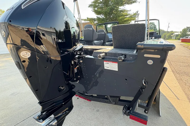 Slide: The Image of 2026 Lund 1875 Pro-V Sport boat with powerful Mercury outboard engine, parked outdoors. - 38