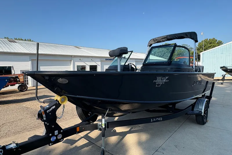 Slide: The Image of 2026 Lund 1875 Pro-V Sport boat on trailer, parked outside a showroom. - 5