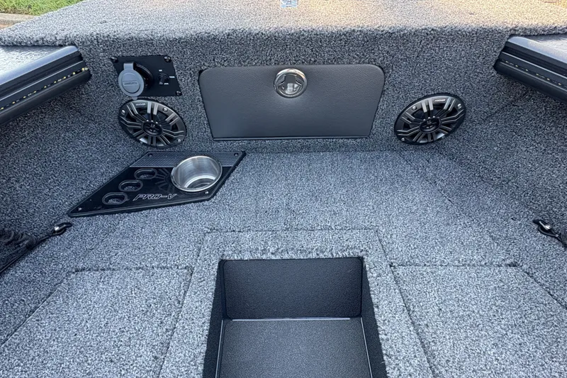 Slide: The Image of 2026 Lund 1875 Pro-V Sport boat interior with speakers and cup holders. - 9