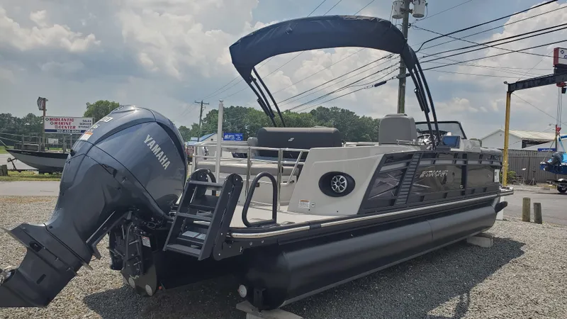 Slide: The Image of 2025 Starcraft MX 23 DL DH pontoon boat with Yamaha outboard motor, parked outdoors. - 12