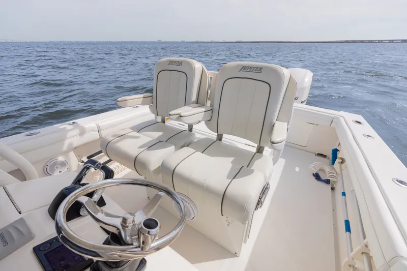 Slide: The Image of 2014 Jupiter 30 boat helm with dual seats on open water. - 12