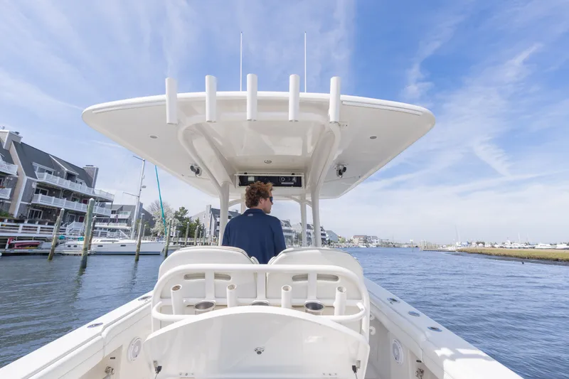 Slide: The Image of Man steering Jupiter 30 boat on waterway, 2014 model. - 18