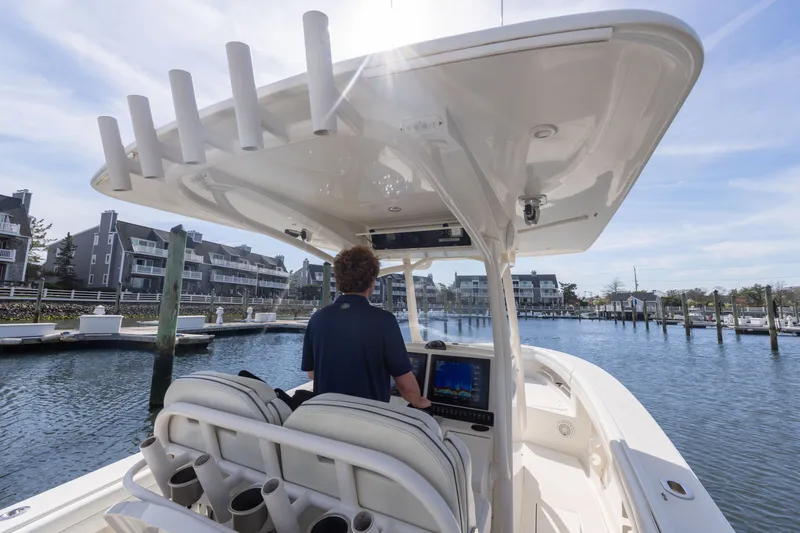 Slide: The Image of Person steering Jupiter 30 boat in harbor, 2014 model. - 19