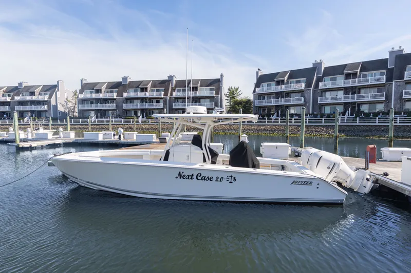 Slide: The Image of 2014 Jupiter 30 boat docked in marina with modern buildings. - 20
