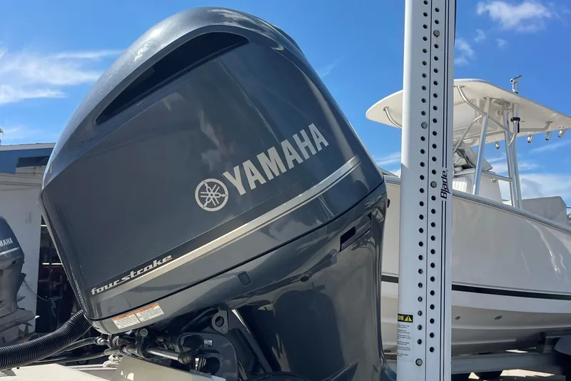Slide: The Image of Yamaha four-stroke outboard motor on 2014 Grady-White Freedom 225 boat, sunny day. - 14