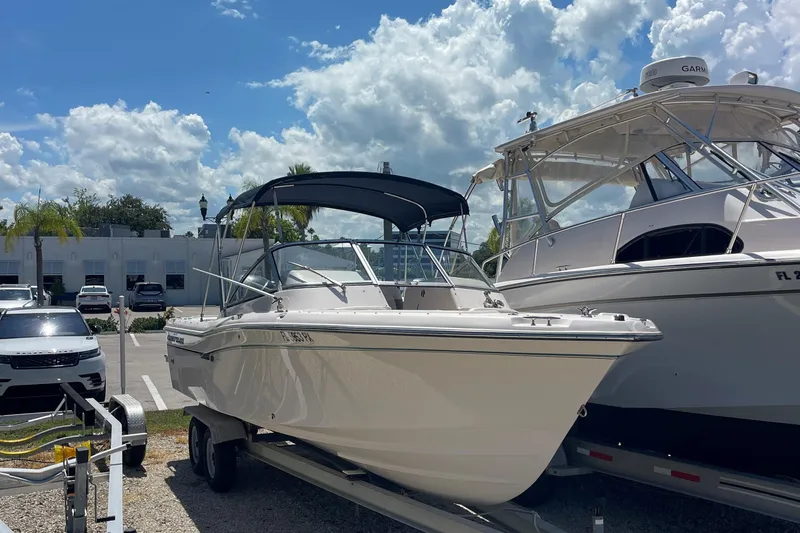 Slide: The Image of 2014 Grady-White Freedom 225 boat on trailer under blue sky. - 5