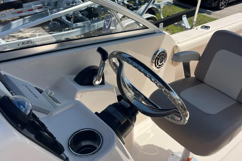 Slide: The Image of 2014 Grady-White Freedom 225 boat cockpit with steering wheel and control panel. - 7