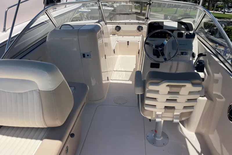 Slide: The Image of 2014 Grady-White Freedom 225 boat interior with steering wheel and seating. - 8