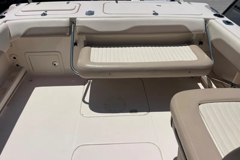 Slide: The Image of 2014 Grady-White Freedom 225 boat interior with beige seating and storage compartments. - 9