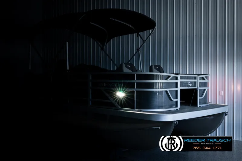 Slide: The Image of 2026 Bennington 168 SFSE pontoon boat in dimly lit showroom, showcasing sleek design. - 4