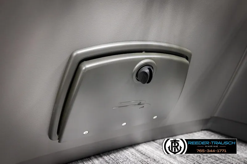Slide: The Image of 2026 Bennington 168 SFSE boat compartment with secure latch, Reeder-Trausch Marine branding. - 45