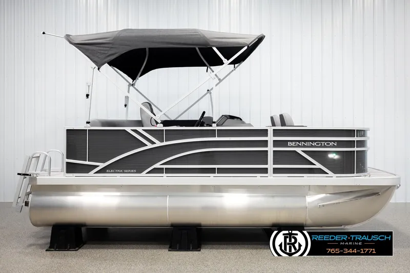 Slide: The Image of 2026 Bennington 168 SFSE pontoon boat with canopy, displayed indoors. - 5