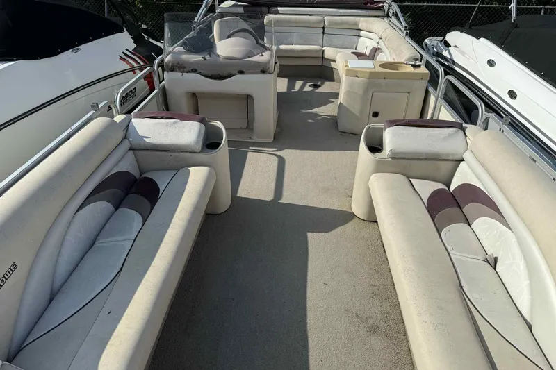 Slide: The Image of 1997 Lowe 240 Family pontoon boat interior with spacious seating and helm. - 12