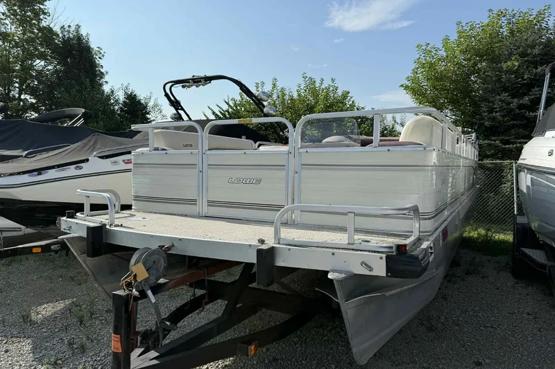 Slide: The Image of 1997 Lowe 240 Family pontoon boat on trailer, parked outdoors. - 15