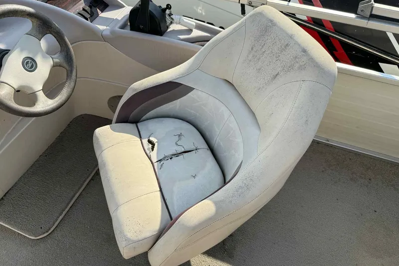 Slide: The Image of Worn boat seat in a 1997 Lowe 240 Family model, showing visible damage and wear. - 6