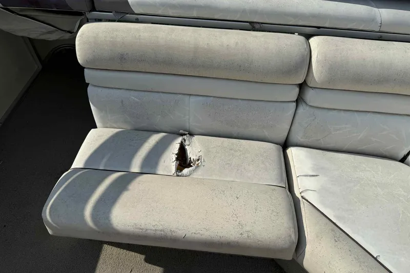 Slide: The Image of Damaged seat on 1997 Lowe 240 Family boat, showing wear and tear. - 7