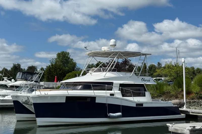 The Image of 2015 Fountaine Pajot Summerland 40 LC catamaran docked under a blue sky. - 0