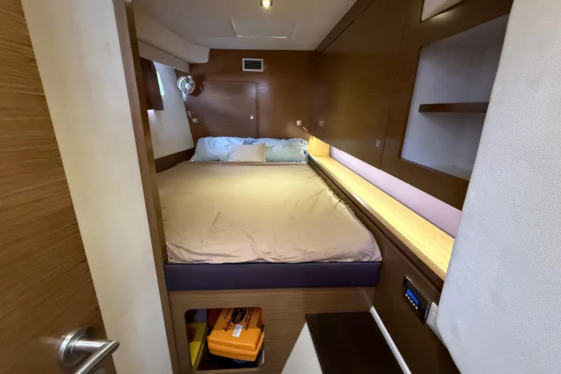 Slide: The Image of Cozy cabin interior of 2015 Fountaine Pajot Summerland 40 LC with wooden accents and bed. - 104