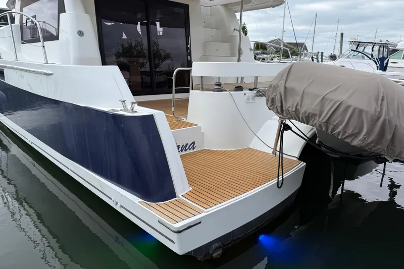 Slide: The Image of 2015 Fountaine Pajot Summerland 40 LC yacht docked, featuring sleek design and wooden deck. - 17