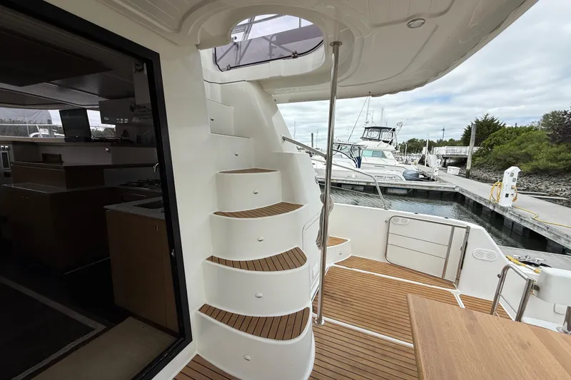 Slide: The Image of 2015 Fountaine Pajot Summerland 40 LC yacht with elegant interior and marina view. - 21
