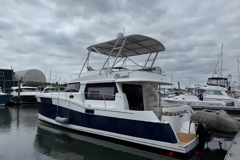 Slide: The Image of 2015 Fountaine Pajot Summerland 40 LC yacht docked at marina under cloudy sky. - 3
