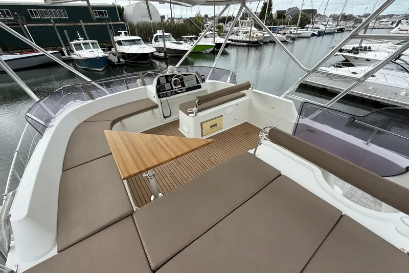 Slide: The Image of Flybridge of 2015 Fountaine Pajot Summerland 40 LC with seating and helm, docked at marina. - 37