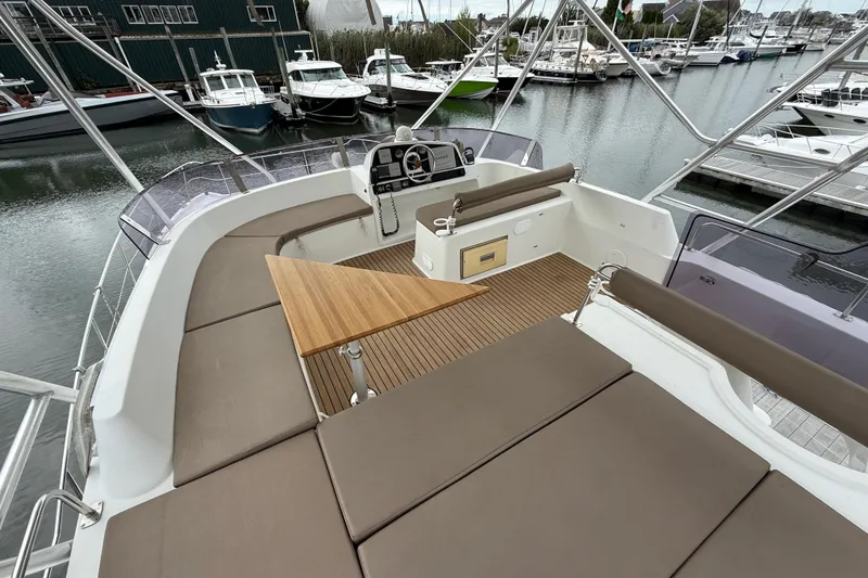 Slide: The Image of Flybridge of 2015 Fountaine Pajot Summerland 40 LC with seating and table, docked at marina. - 38