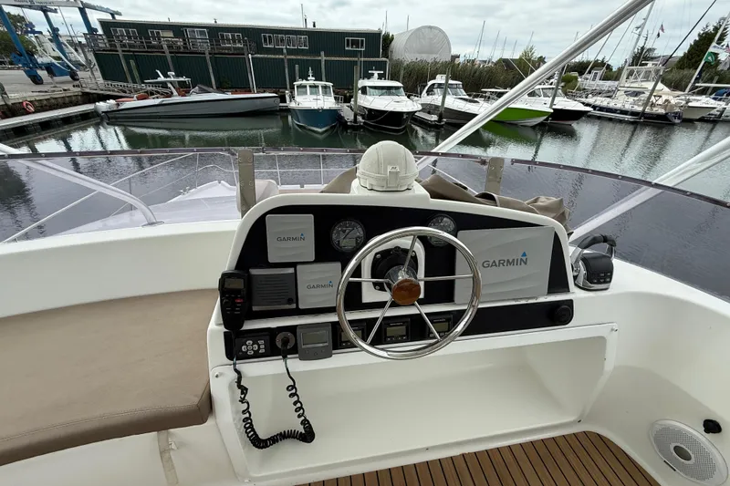 Slide: The Image of Helm of 2015 Fountaine Pajot Summerland 40 LC with Garmin navigation, docked at marina. - 40