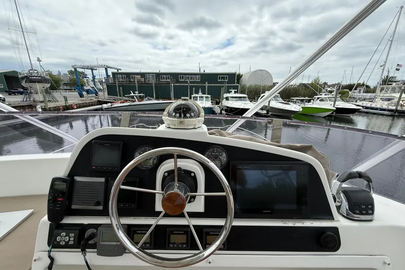 Slide: The Image of Helm of 2015 Fountaine Pajot Summerland 40 LC with marina view in background. - 43